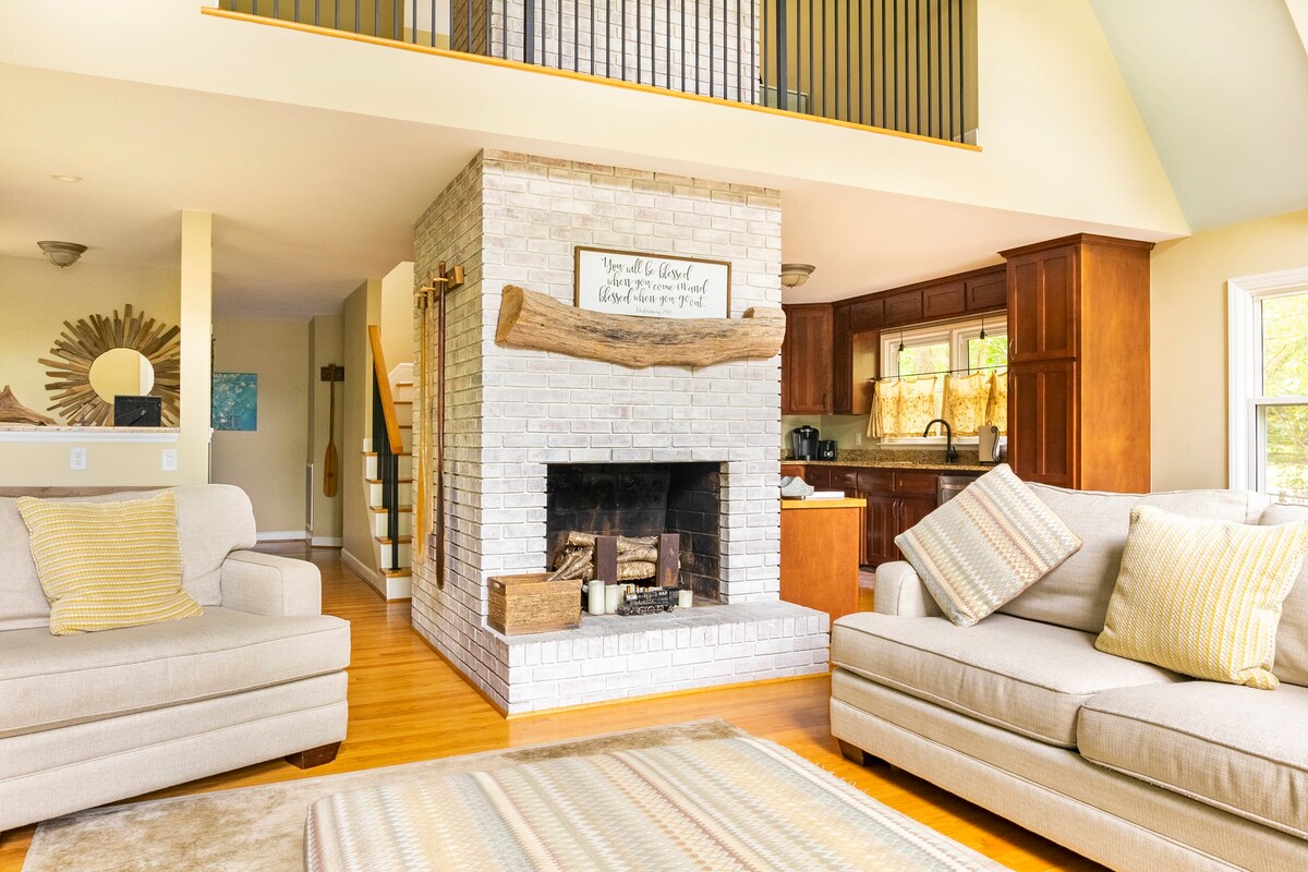 Open concept living room with fireplace and vaulted ceilings