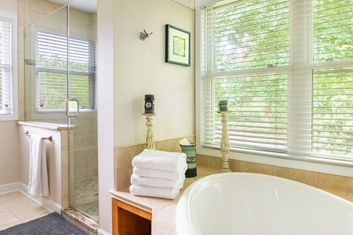 Spa-style bathroom with soaking tub and abundant windows