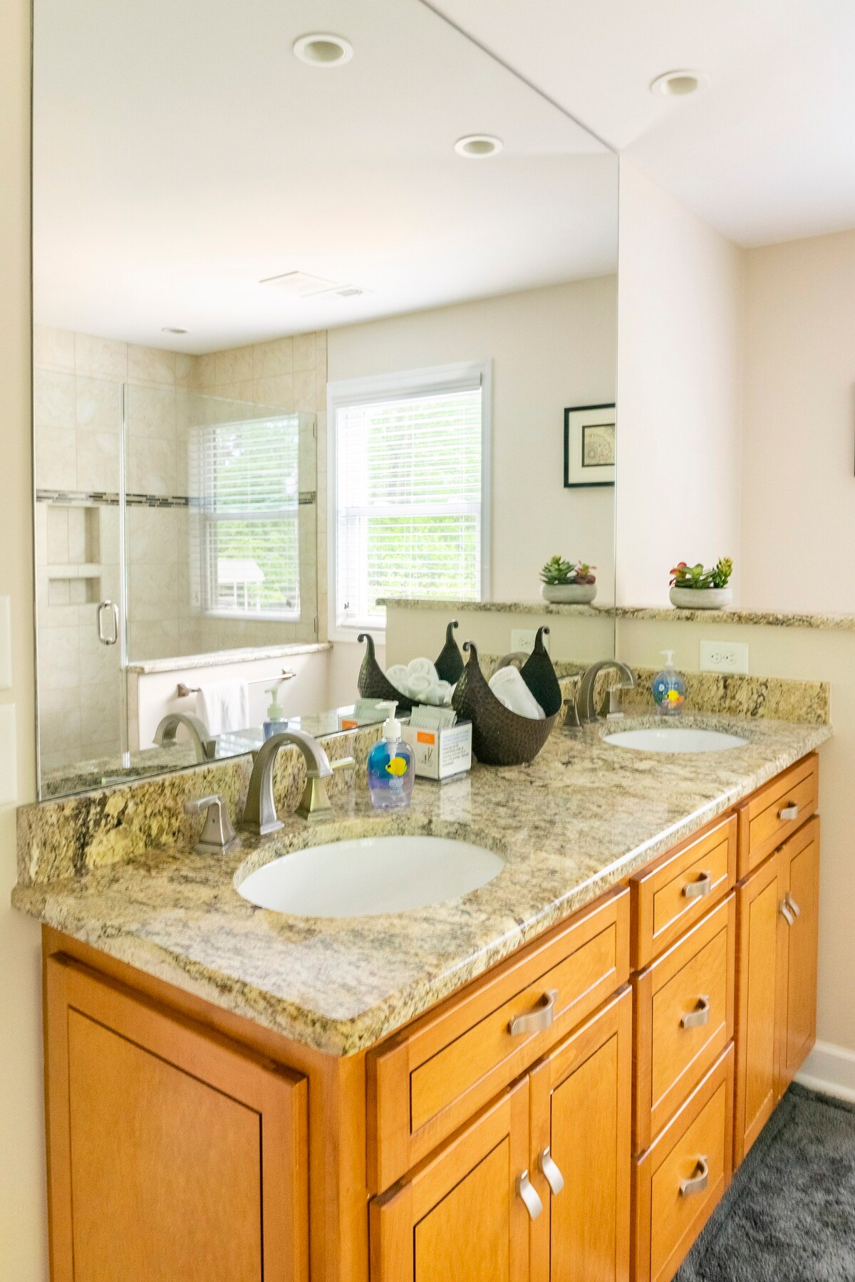 Master bathroom with double vanity and granite countertops