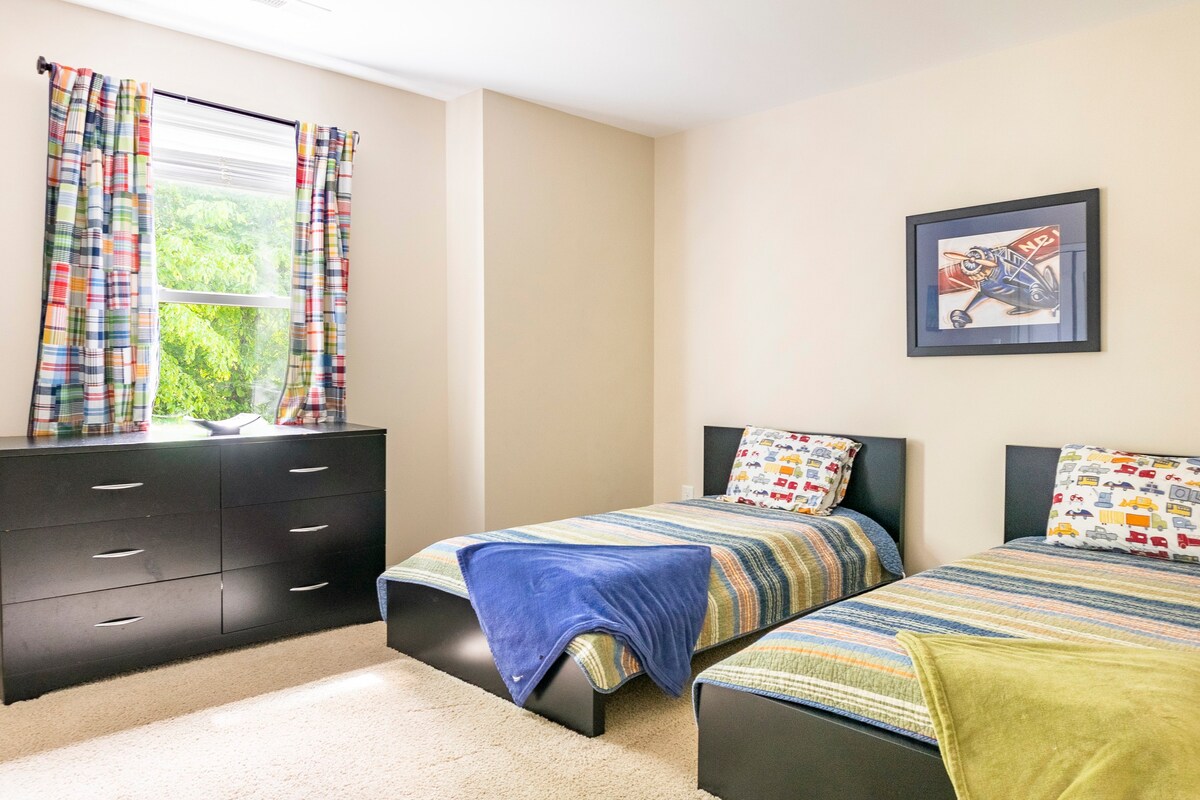 Kids bedroom with twin beds and transportation-themed decor