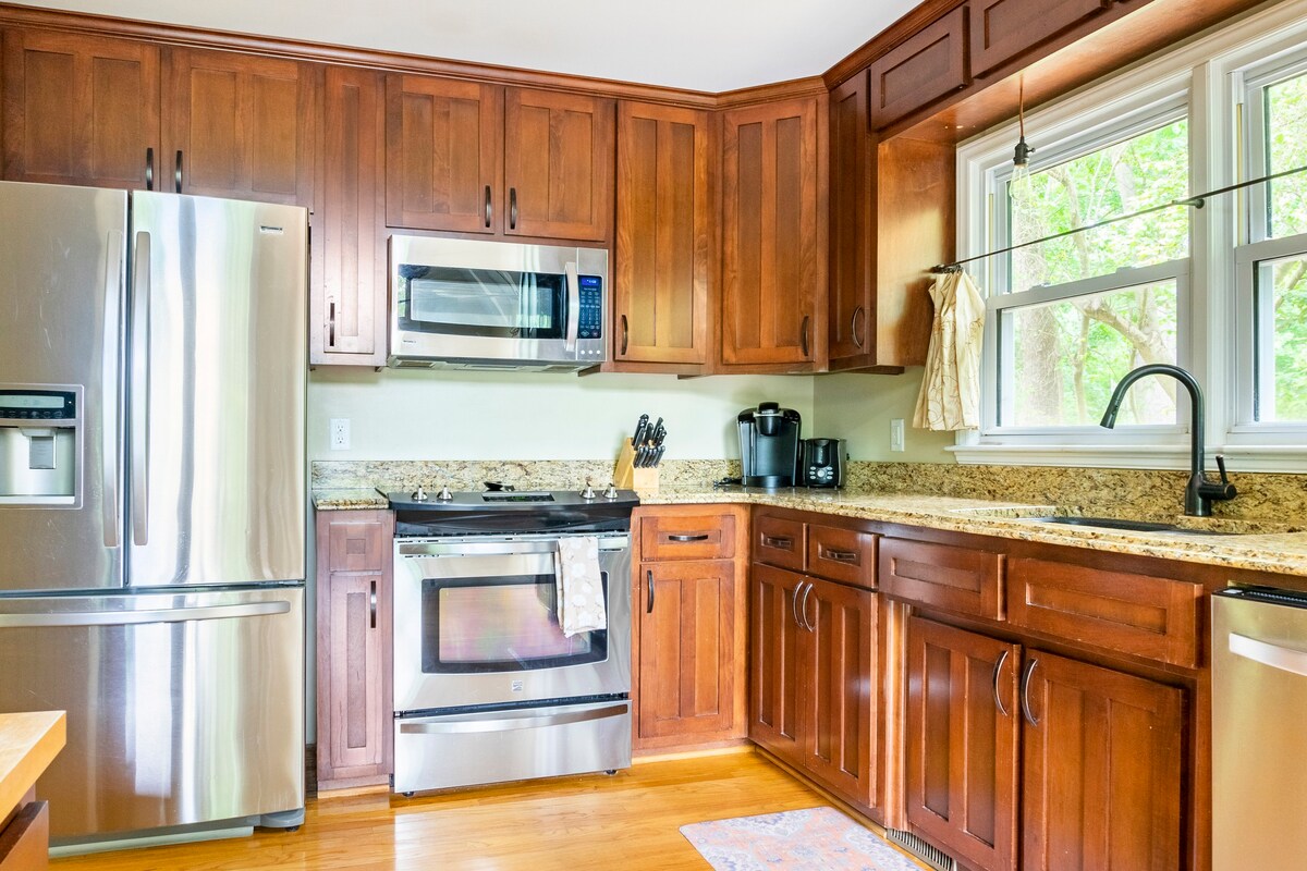 Kitchen with extensive cabinetry, granite counters, and modern appliances