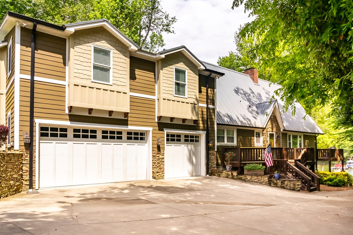 Beautiful lakehouse exterior with garage and stone accents