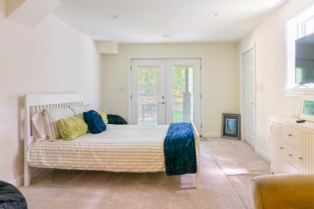 Bedroom with white furniture and outdoor patio access