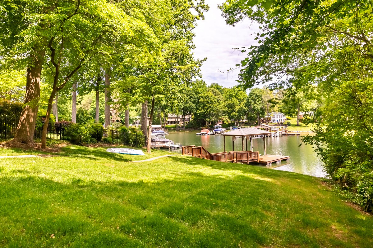 Manicured lawn with lakefront access and dock