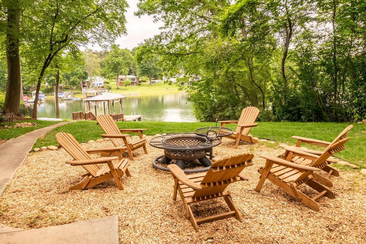 Lakefront fire pit area with Adirondack chairs