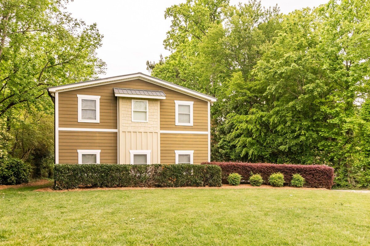 Rear exterior with traditional architecture and landscaping
