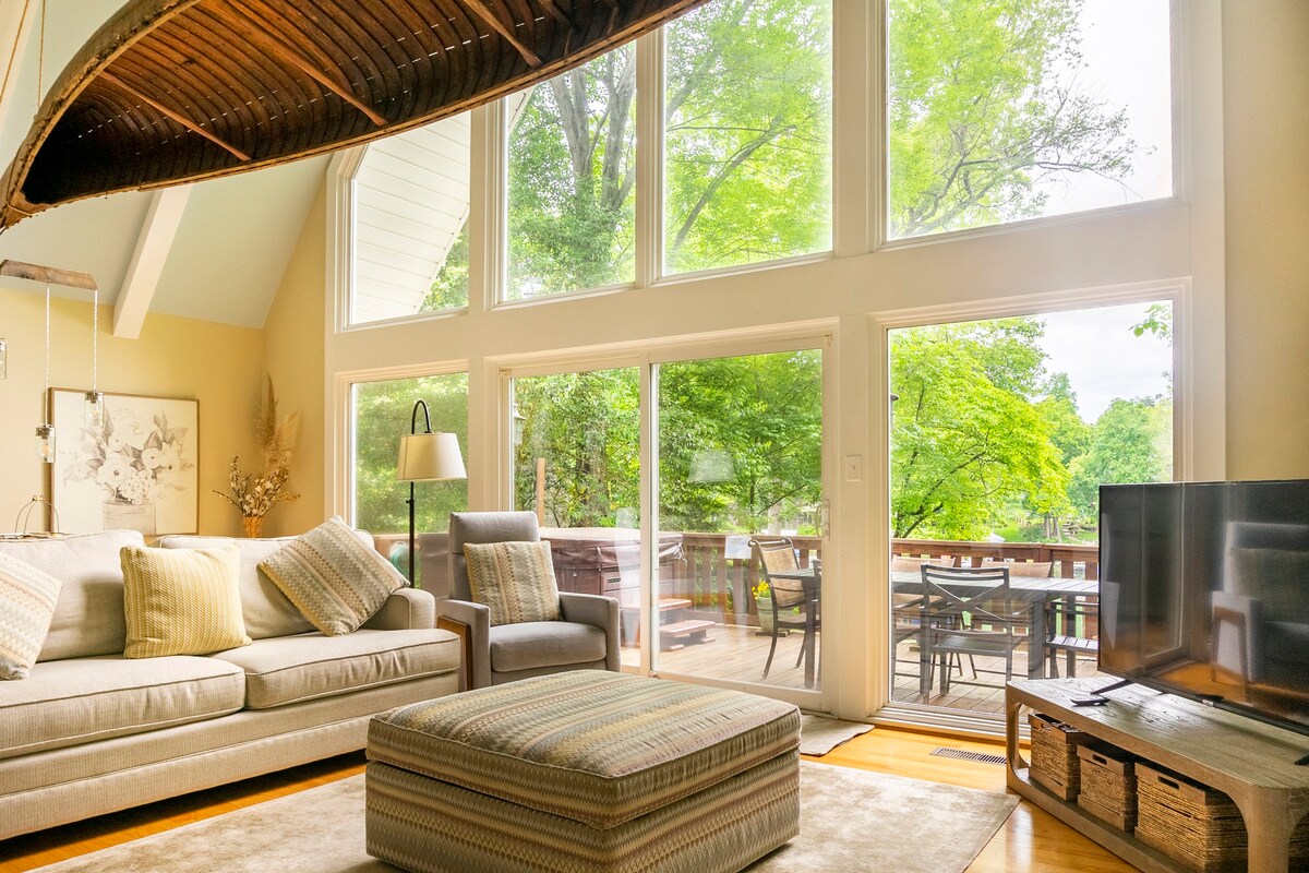 Cathedral ceiling living room with floor-to-ceiling windows